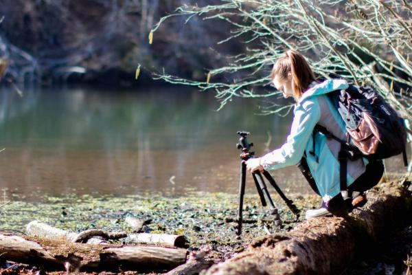 Student along a creek setting up for field work.