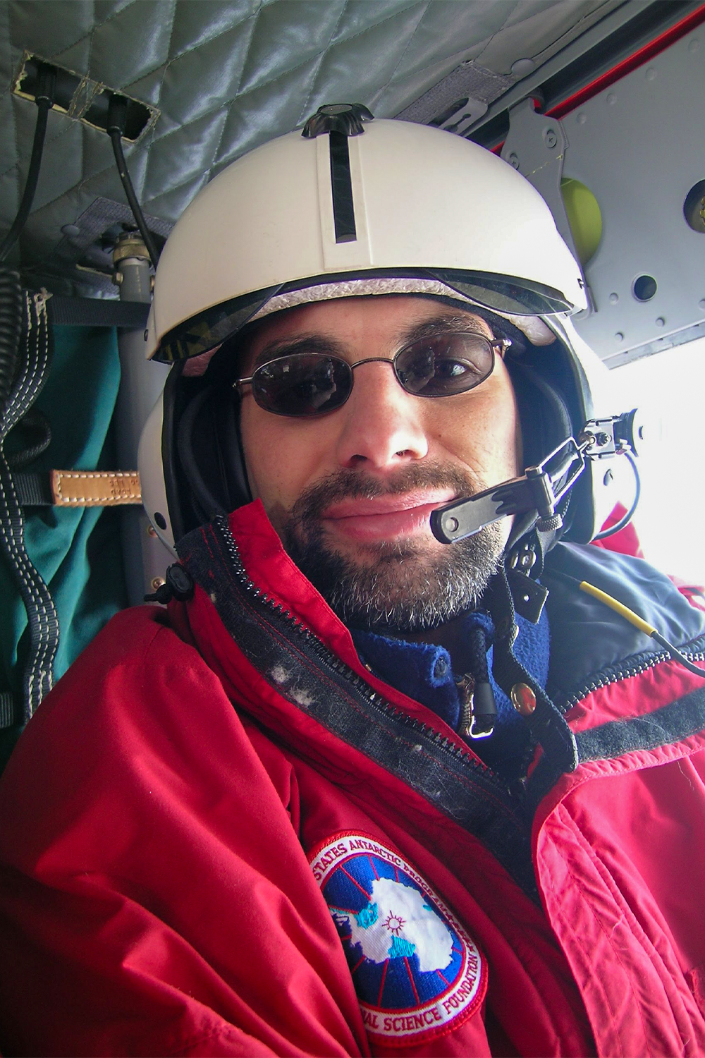 Sasha Tozzi Ph.D. ’10 during a helicopter transfer in Antarctica in January 2004. Photo provided by Sasha Tozzi.