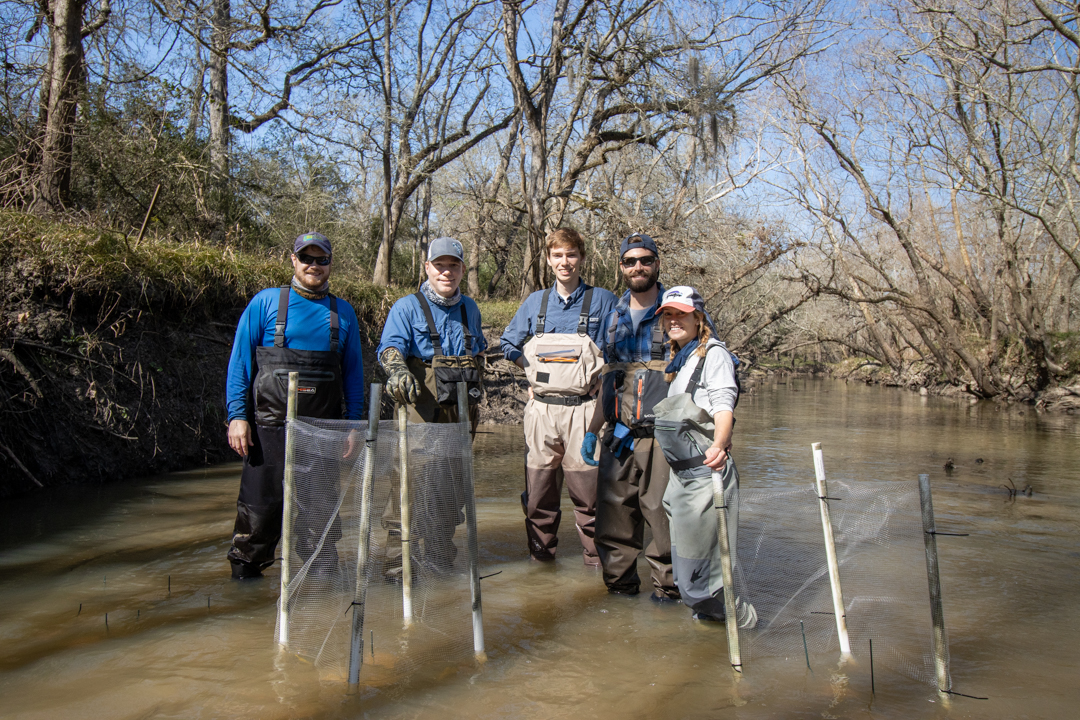 Members of the research team pose for a group photo during field work. Photo by Chris Patrick.